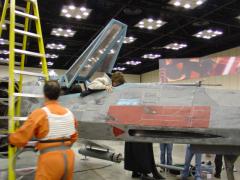 55fb9b24ab353_child_gets_in_X_wing_pilot_stands_by1.JPG